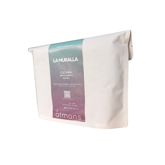 A white stand-up pouch of La Muralla Colombia Premium Washed coffee from Atmans, featuring a vertical label with a teal-to-purple gradient.